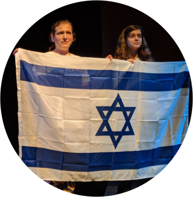 Two young adults holding the Israeli flag