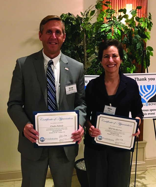 Man holding certificate of recognition for Charles Schwab standing next to woman holding certificate of recognition for MVP Healthcare