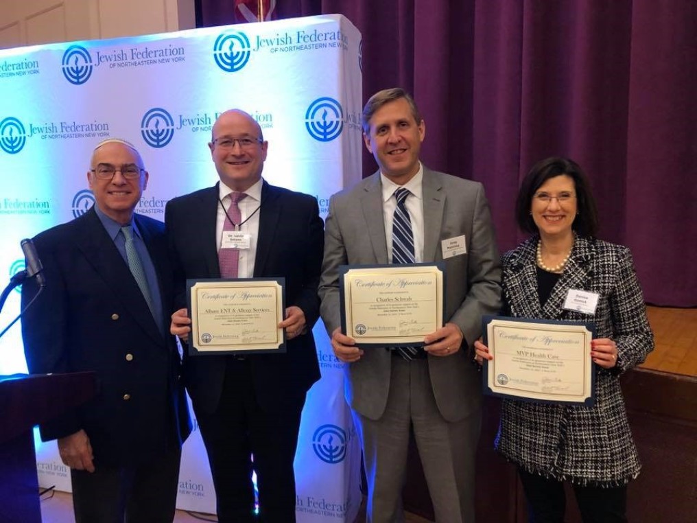 Past Federation chair, Louis-Jack, standing next to representatives from Albany ENT & Allergy Services, Charles Schwab, and MVP Health Care holding certificates of recognition