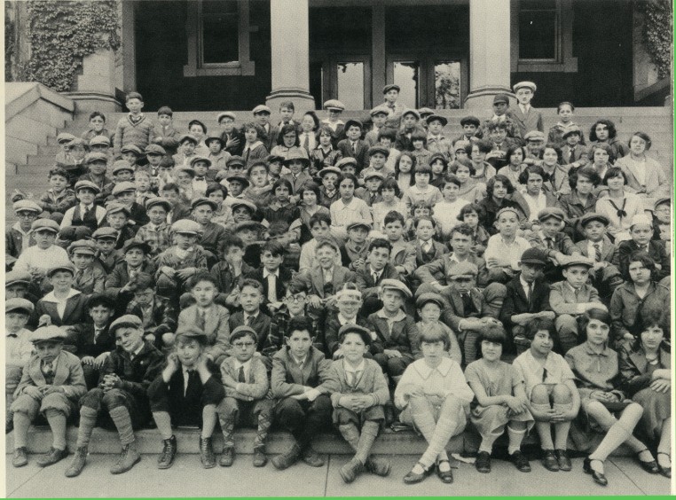 Boys and girls sit on the steps of the Cincinnati Talmud Torah Society School