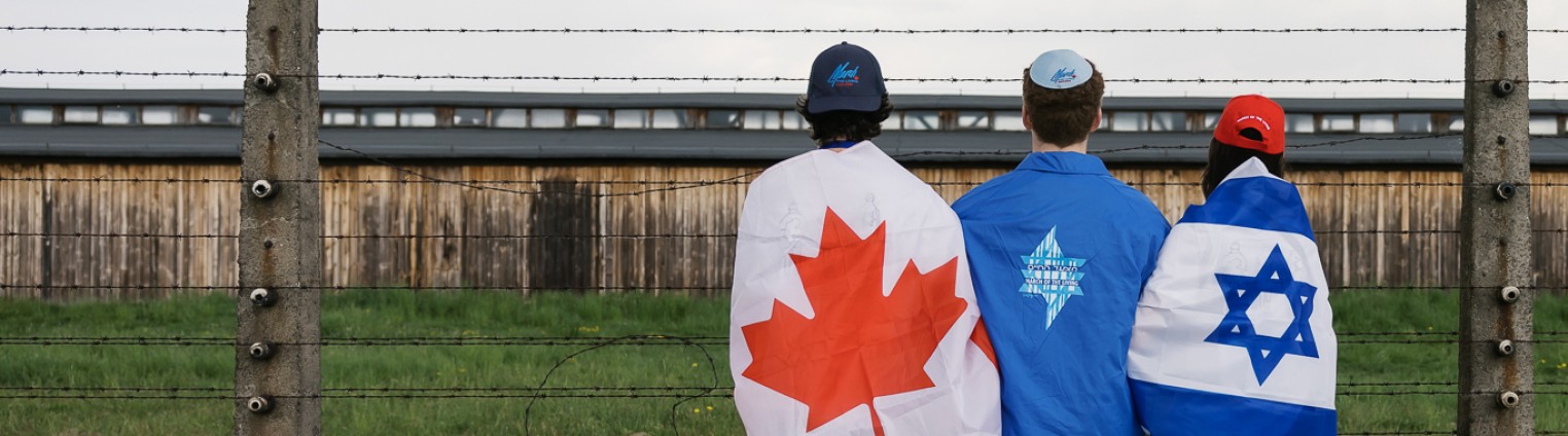 Three individuals stand side by side, wearing a Canadian flag, an Israeli flag, and a blue jacket with a Star of David.