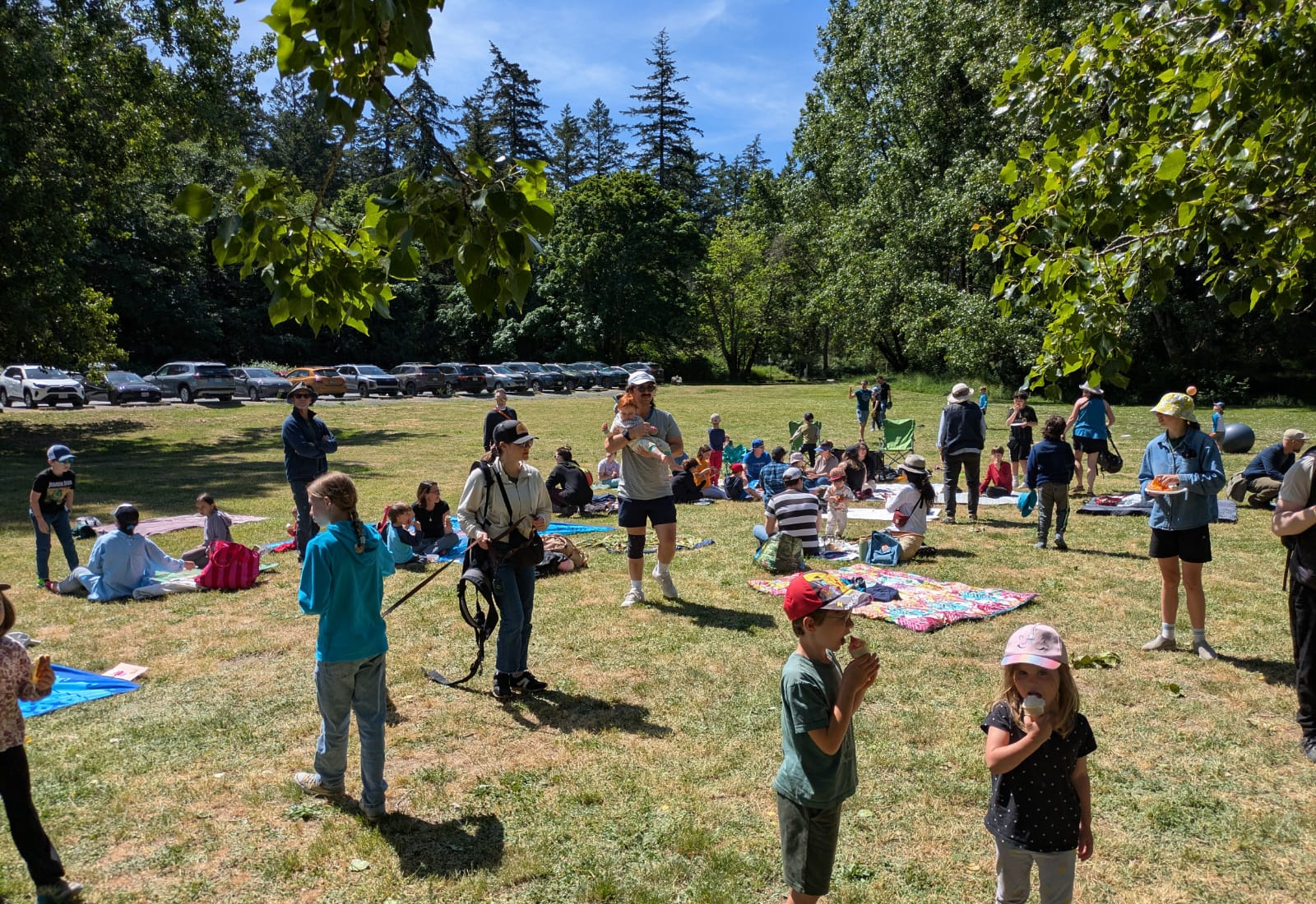 Families and community members gathering outdoors on Vancouver Island