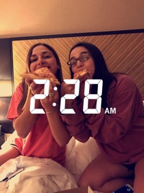 Hannah Wise and Yael Friedstrom enjoy their late-night pizza while spending the night at an airport hotel in Newark.